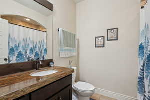 Bathroom featuring vanity, tile patterned flooring, and toilet