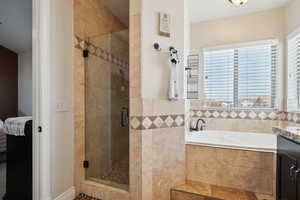 Bathroom with vanity and plus walk in shower