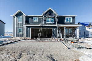 Rear view of property with a garage and a porch