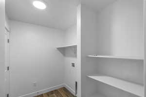 Washroom featuring hardwood / wood-style flooring and hookup for a washing machine