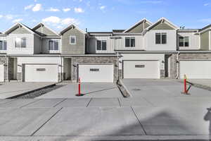 Townhome / multi-family property featuring a garage