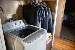 Laundry room featuring washer / clothes dryer and hardwood / wood-style floors