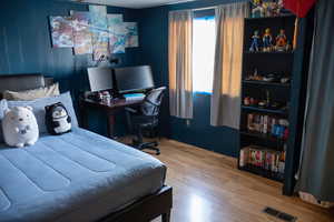 Bedroom with wood-type flooring