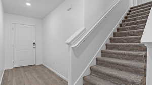 Staircase with hardwood / wood-style floors