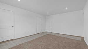 Empty room with light colored carpet