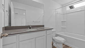 Full bathroom featuring shower / tub combination, toilet, hardwood / wood-style floors, and vanity