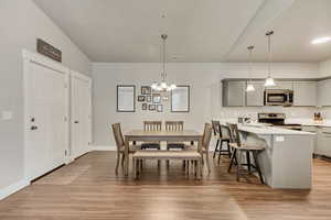 Dining area featuring light hardwood / wood-style flooring and a chandelier