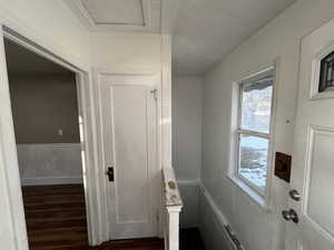 Bathroom with a textured ceiling and wood-type flooring