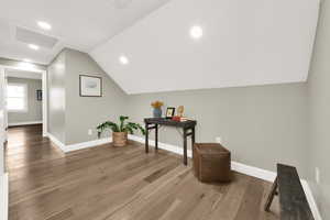 Interior space featuring hardwood / wood-style flooring and vaulted ceiling