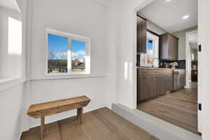 Corridor with a healthy amount of sunlight and hardwood / wood-style flooring