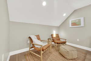 Living area featuring light hardwood / wood-style floors and vaulted ceiling