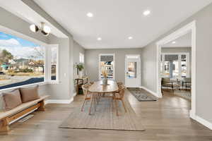 Dining room with light hardwood / wood-style floors and a notable chandelier