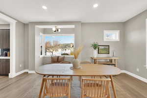 Dining area with light hardwood / wood-style floors and a healthy amount of sunlight