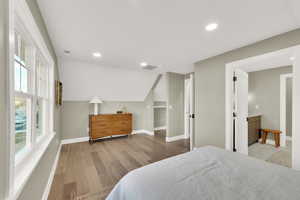 Bedroom featuring lofted ceiling and wood-type flooring