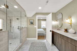 Bathroom featuring a shower with door and vanity