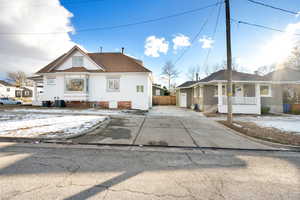 View of front of property with central AC unit and covered porch