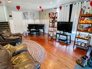 Living room with wood-type flooring and a textured ceiling