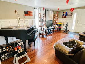 Living room with hardwood / wood-style flooring and a textured ceiling