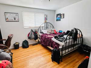 Bedroom with wood-type flooring