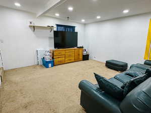 Living room featuring carpet flooring and beam ceiling