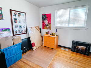 Miscellaneous room with a fireplace and light wood-type flooring