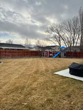 View of yard featuring a playground and a patio area