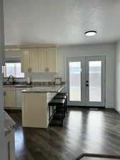 Kitchen with a wealth of natural light, dishwasher, sink, and stone countertops