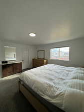 Bedroom featuring a textured ceiling and carpet floors