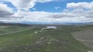 Birds eye view of property with a water and mountain view