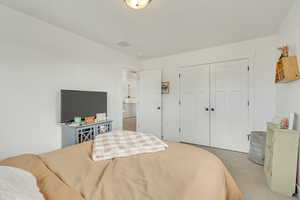 Bedroom with a closet and carpet floors