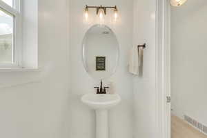 Bathroom with hardwood / wood-style flooring