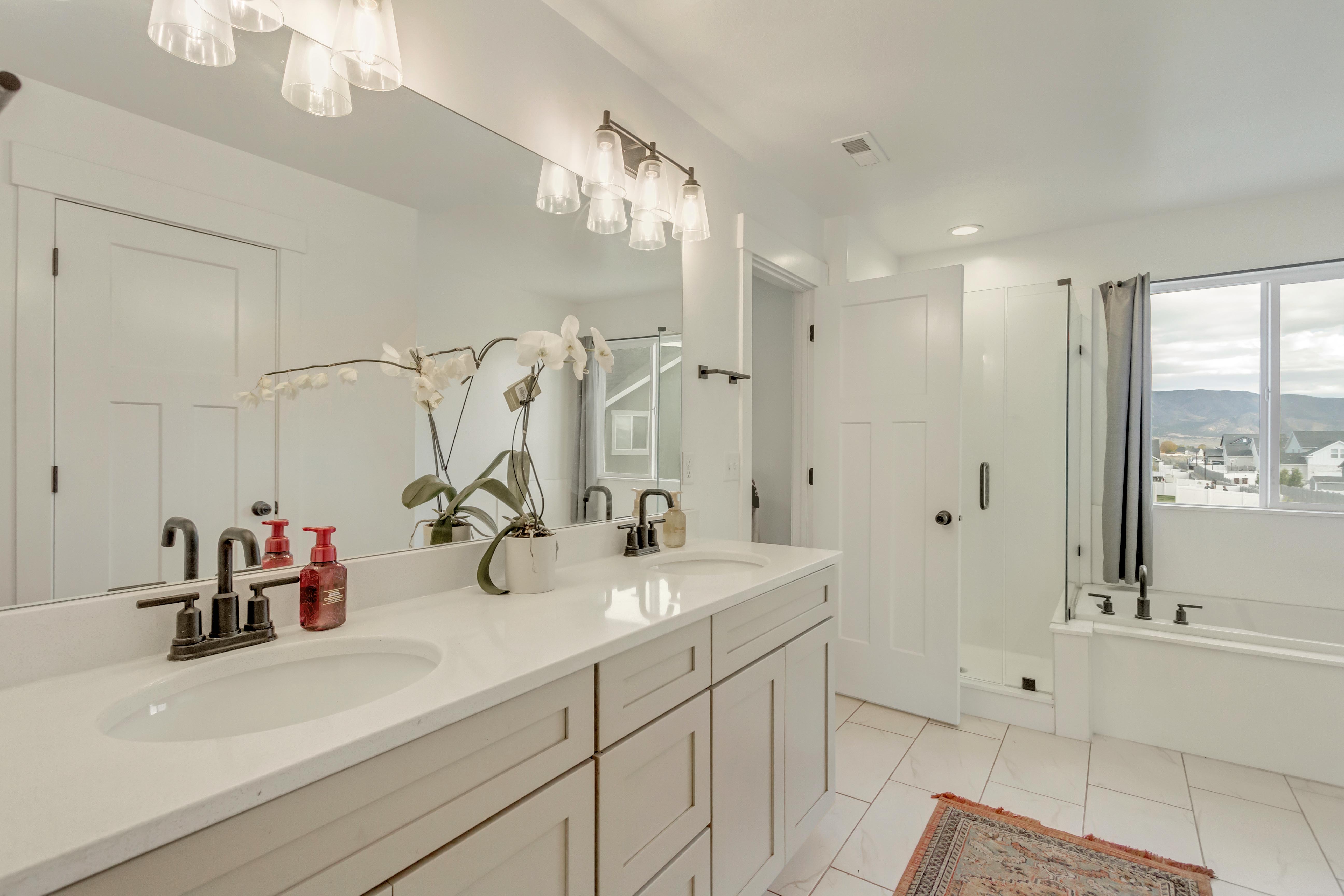 Bathroom with vanity, tile patterned flooring, and plus walk in shower