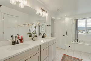 Bathroom with vanity, tile patterned flooring, and plus walk in shower