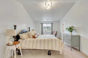 Carpeted bedroom with vaulted ceiling