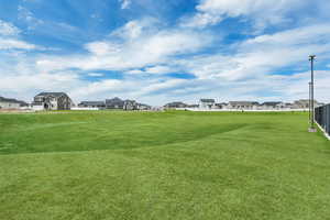 View of home's community with a yard