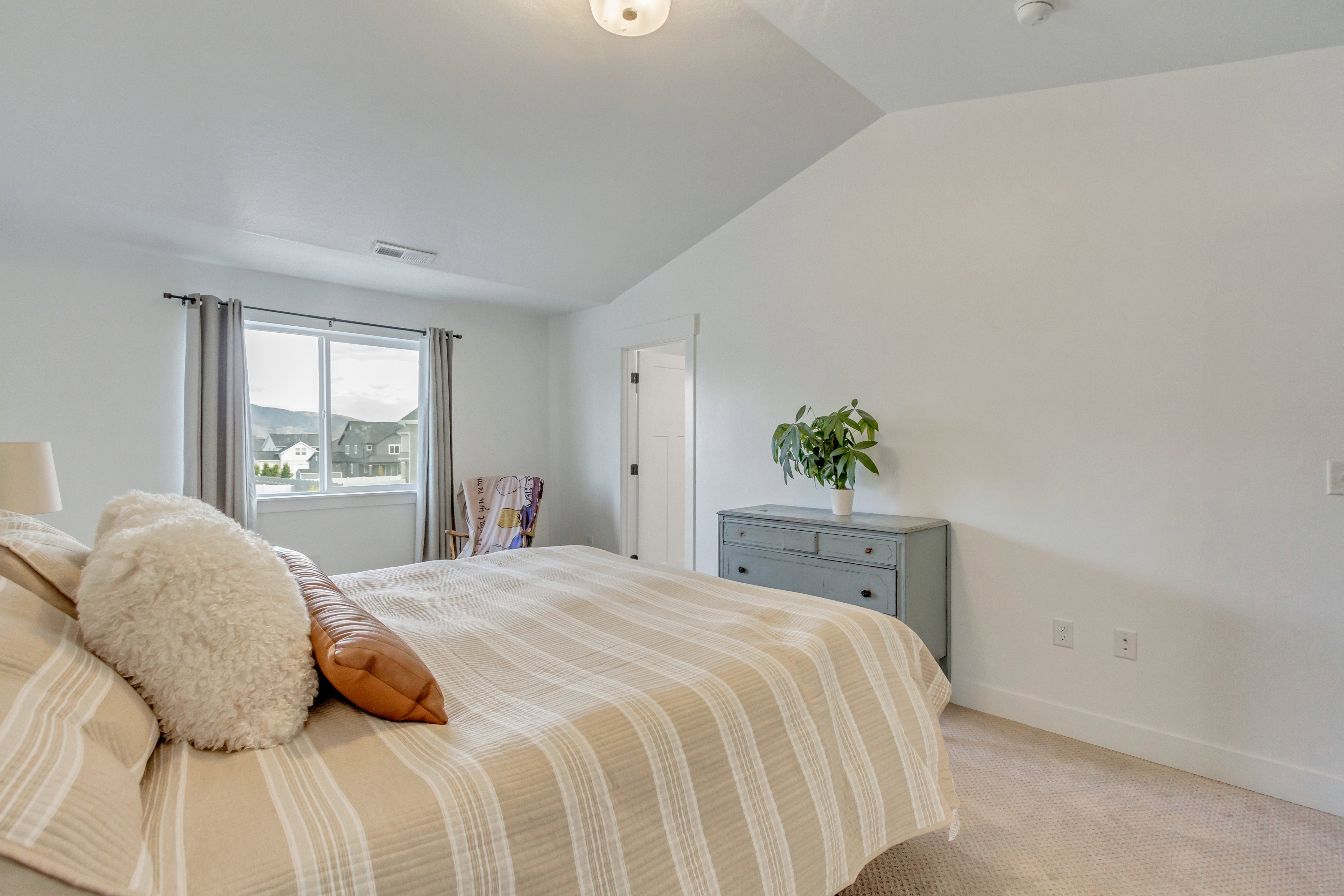 Bedroom featuring vaulted ceiling and light colored carpet