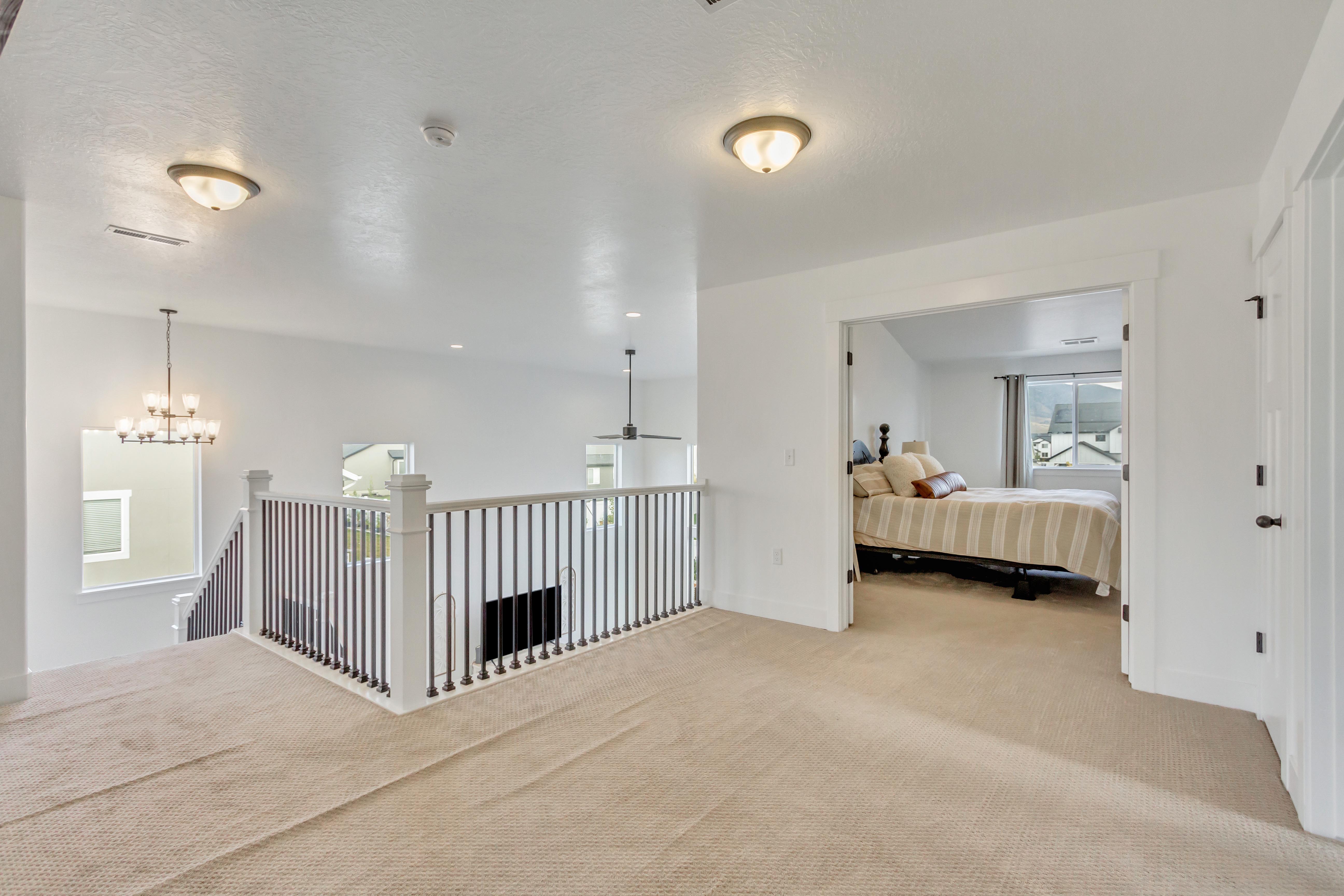 Hall with a chandelier, carpet flooring, and a textured ceiling