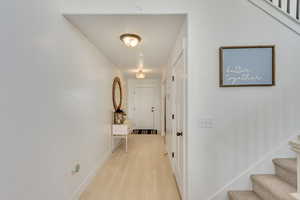 Hall with light hardwood / wood-style floors