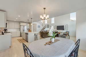 Dining room featuring light hardwood / wood-style floors, a notable chandelier, and sink