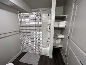 Bathroom featuring shower / bath combo with shower curtain and hardwood / wood-style flooring