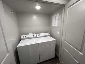 Laundry room featuring dark wood-type flooring and separate washer and dryer