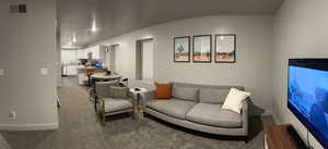 Living room with carpet and vaulted ceiling