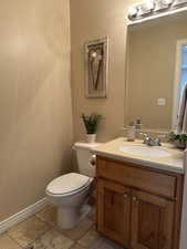 Half Bath off the garage entry with toilet and vanity