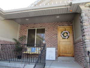 View of front covered porch and front door entrance