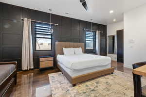 Bedroom with ceiling fan and multiple windows