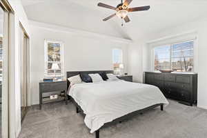 Primary Bedroom with multiple windows and lofted ceiling