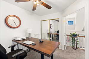 Bedroom or office space with view of living room and lofted ceilings