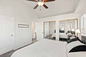 Primary Bedroom with multiple windows and lofted ceiling