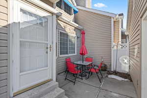 View of exterior entry with a patio