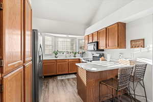 Kitchen featuring black appliances & tons of natural light